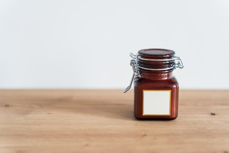 Scented candle in a glass jar on a white backgroundの写真素材