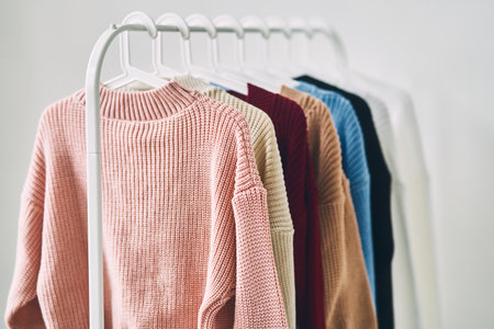 multicolored womens woolen sweaters on hangers. Sale in a fashion storeの写真素材