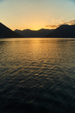 View of the sunset in Boko-Kotor Bay in Montenegro. Silhouettes of mountainsの写真素材