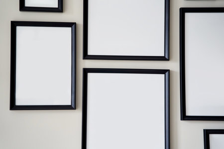 Different size framed photos hanging on the gray wall. Mockup.