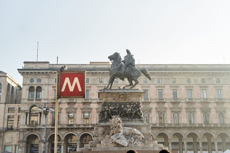 Milan, Italy - February 15, 2023: A vibrant plaza with a stunning iconic statue and prominent metro signage that captivatesのeditorial素材