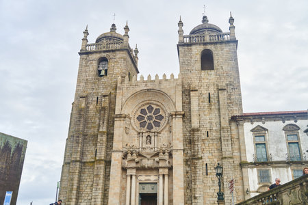 Porto, Portugal - 12.25.2022: A historic cathedral with a breathtaking facade and grand stone steps to its entranceのeditorial素材