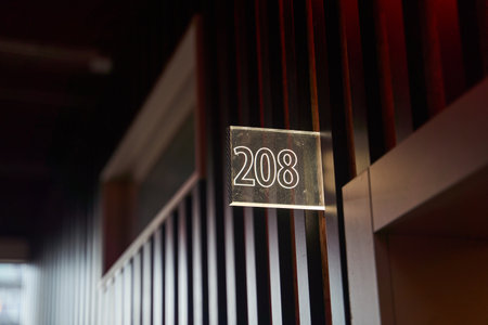Glowing white room number plate in hotelの写真素材