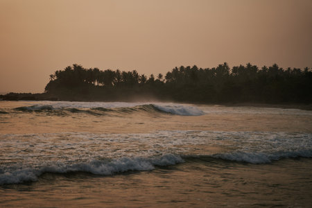 Sunset on the ocean with big waves in Sri Lankaの写真素材