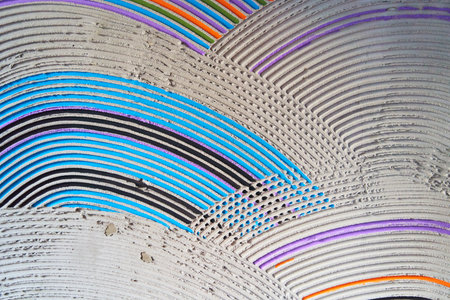 Textured multicolored semicircles on a cement wall. Decorative rough puttyの写真素材