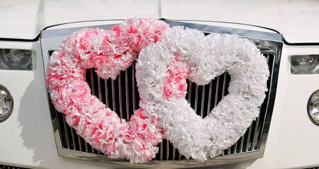 Wedding car decorated with flowers in the shape of heartsの写真素材