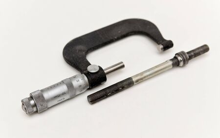 Old micrometer and metal rod with nutの写真素材