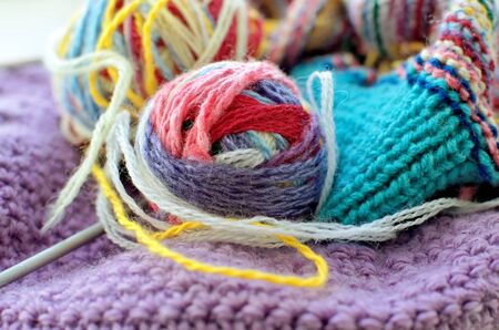 Colorful balls of wool, threads and a needle for knittingの写真素材