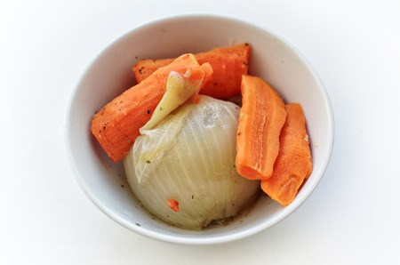 Cooked onions and carrots in a circular Cup - top viewの写真素材