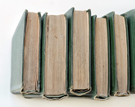 An old stack of green books on the shelf, works - top viewの写真素材