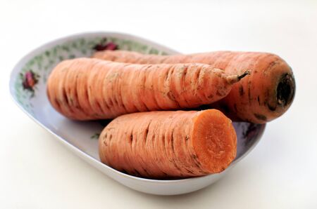 Fresh carrots into oblong plate - side viewの写真素材