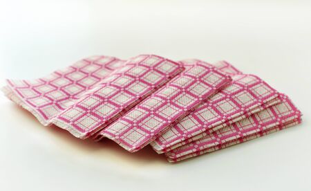 Colored paper napkins laid out in a pile closeupの写真素材