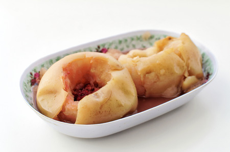 Two apples baked in the oven on an oblong plateの写真素材