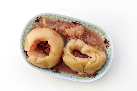 Two apples with jam baked in the oven on an oblong plateの写真素材