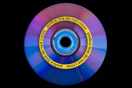 a dvd with yellow police line on it's surfaceの写真素材