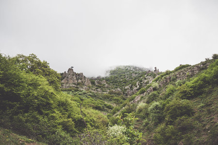 View of a mountain with pillars covered with thick clouds. Demerdji, Russia.