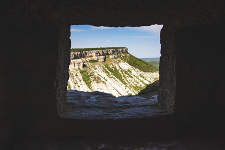 View of the valley and the mountain from the hole in the cave.の写真素材