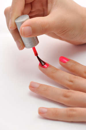 Painting nails with pink colorの写真素材