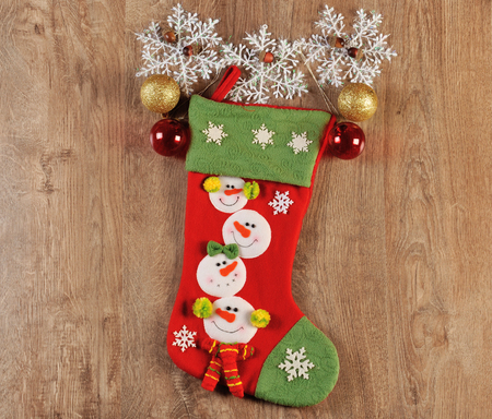 christmas balls and boot on wood floorの写真素材