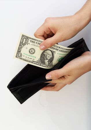 Person taking one dollar bill money from black walletの写真素材