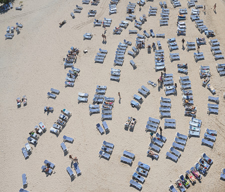 People relaxing on beach chairs in caribbeanの写真素材