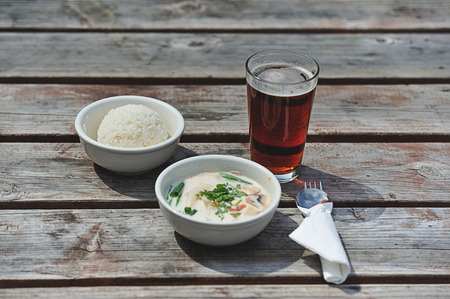 Lunch of rice with root beer and spicy soupの写真素材