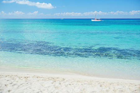 view of boat moving in crystal water from beachの写真素材