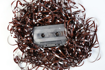 Audio casette on top pf tape on a white backgroundの写真素材