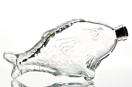 Empty fish shape bottle on a white backgroundの写真素材