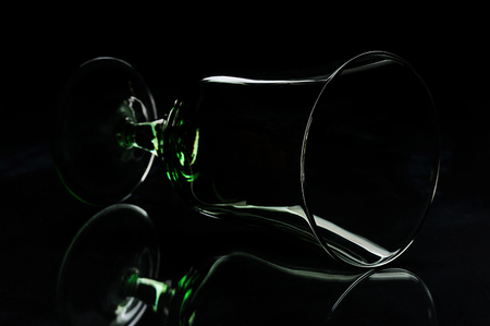 silhouette of glass laying on a black backgroundの写真素材