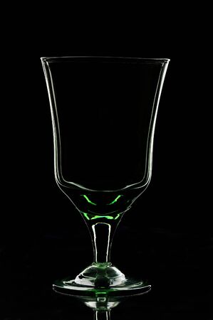 silhouette of empty glass staying on a black backgroundの写真素材