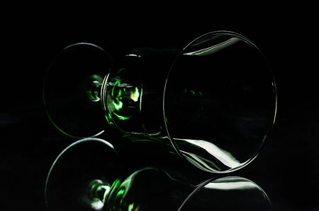 silhouette of glass laying down on a black backgroundの写真素材