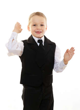 happy boy kid in black suit isolated on whiteの写真素材