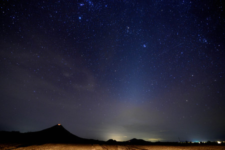Volcano crater at night at valley with sky full of starsの写真素材