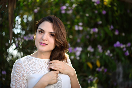 spanish pretty girl hold her hair in green parkの写真素材