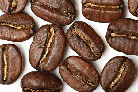 close up of coffee beans isolated on white background