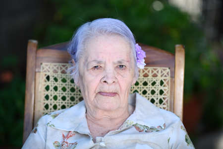 portrait of suspicious grandma outside in parkの写真素材