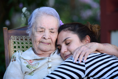 Grandma hugging her grandaugtherの写真素材