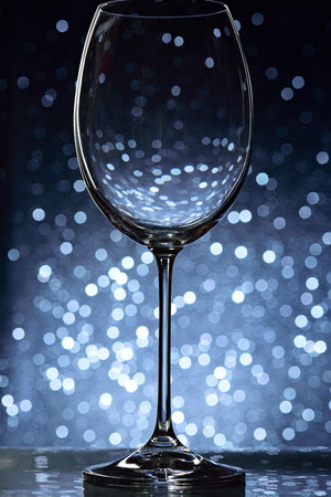 elegant wine glass on bokeh blurred backgroundの写真素材