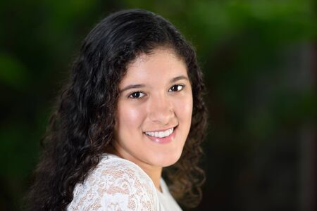 sideway headshot of teen girl with curly hairの写真素材