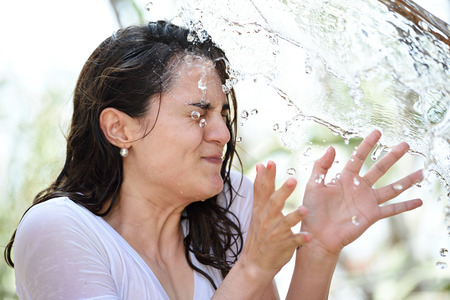close up of  woman face with water drops on itの写真素材