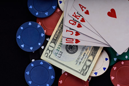 gamble set chips cards and money on black table