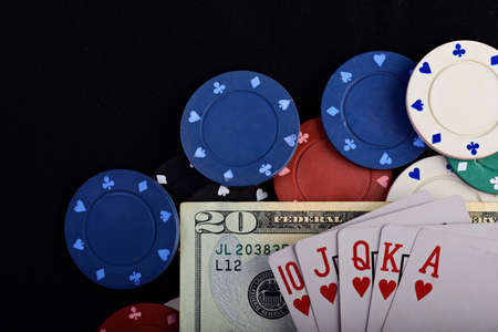 gambling chips and cards with dollar on black tableの写真素材