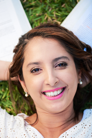 happy smiling  girl lay on grass with boosの写真素材