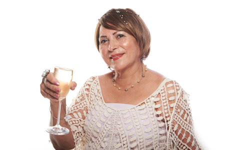 old lady celebrating with a glass of champagneの写真素材