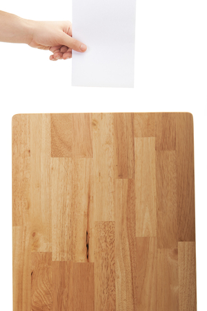 hand put paper on wood box isolated on whiteの写真素材