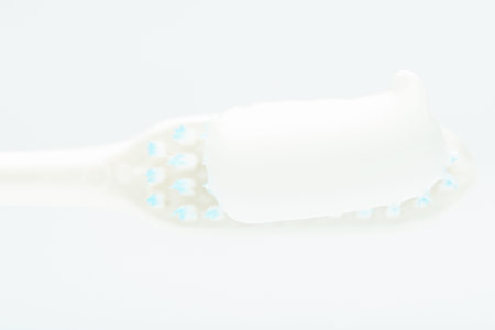 macro of white tooth paste on brush isolated