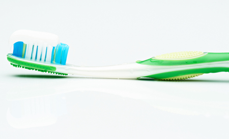 macro of tooth brush and paste isolated on whiteの写真素材