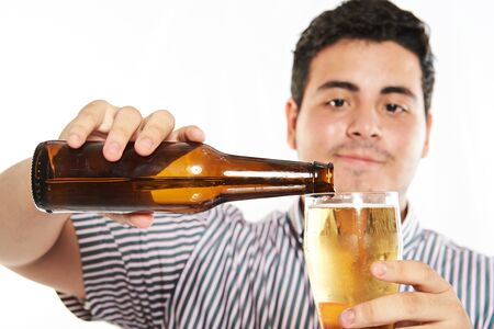 macto of man pouring beer from bottle isolated on whiteの写真素材
