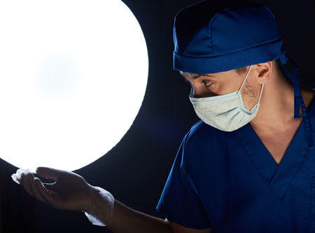 doctor wait for instrument in clinic surgeryの写真素材